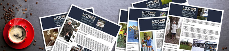 Life Home Design seasonal newsletters beside a red coffee cup