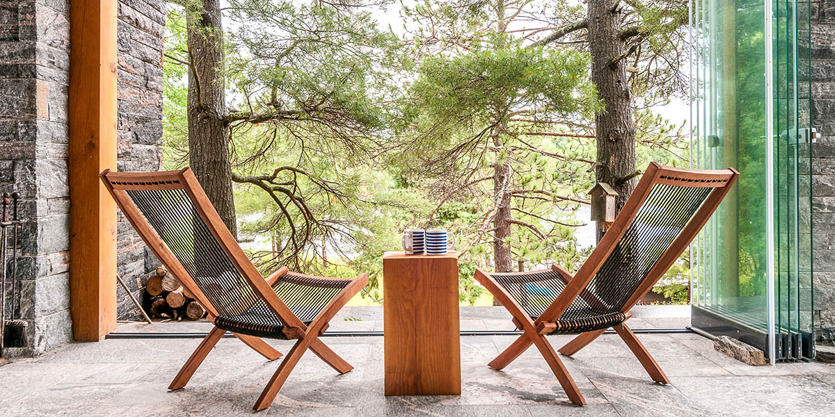 Covered porch with wooden lounge chairs