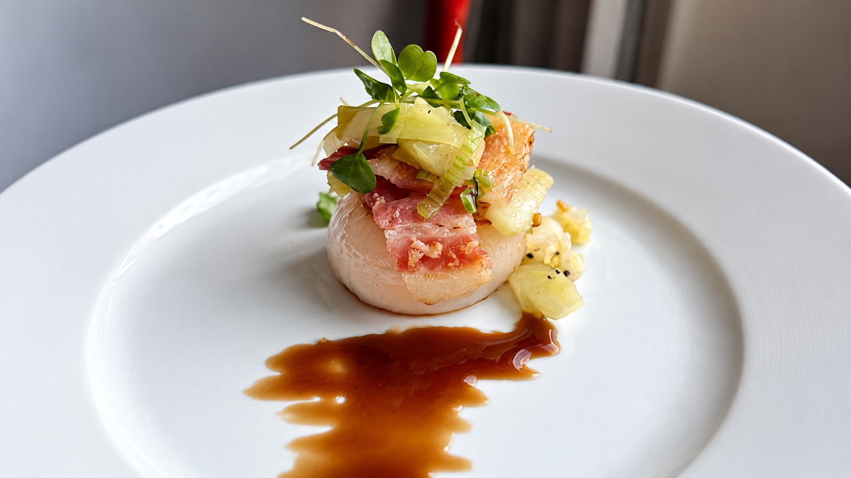 Seared scallop with bacon and microgreens at The Curly Willow Eatery
