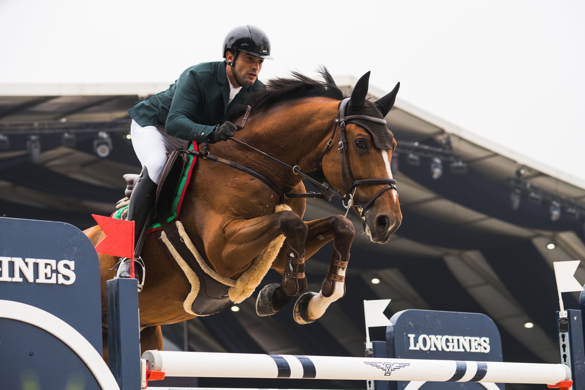 Horse and rider clearing a show jump