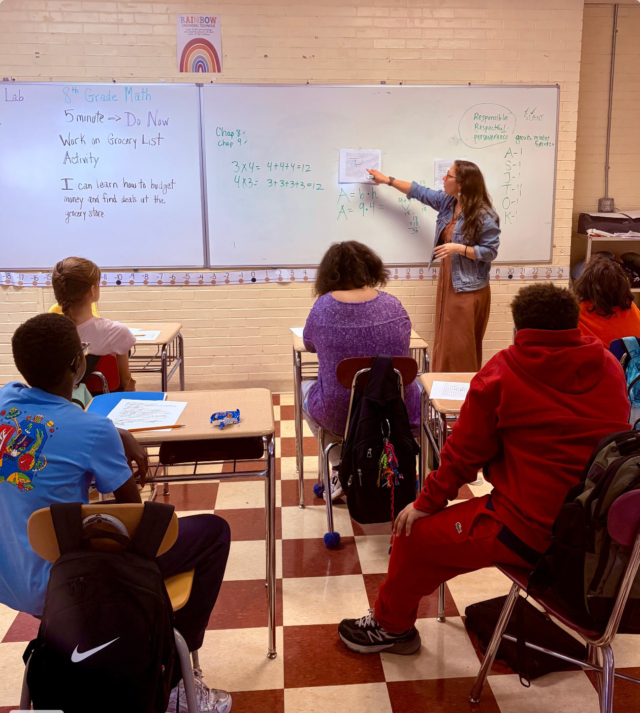 Jes Carter teaching a Greek Mythology Minotaur's lair lesson on the area of a parallelogram at Lincoln Middle School