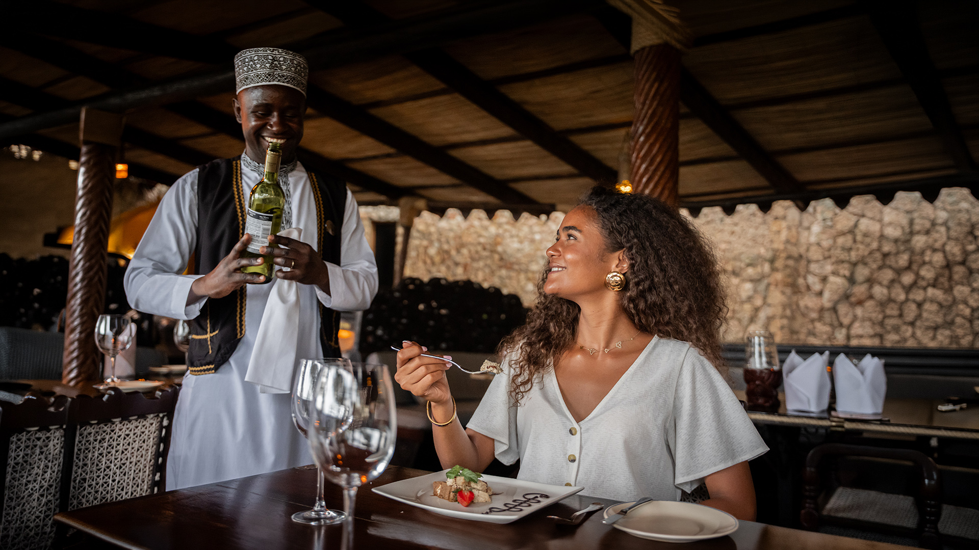 Waiter presenting wine to a guest during dinner at a North Coast resort restaurant
