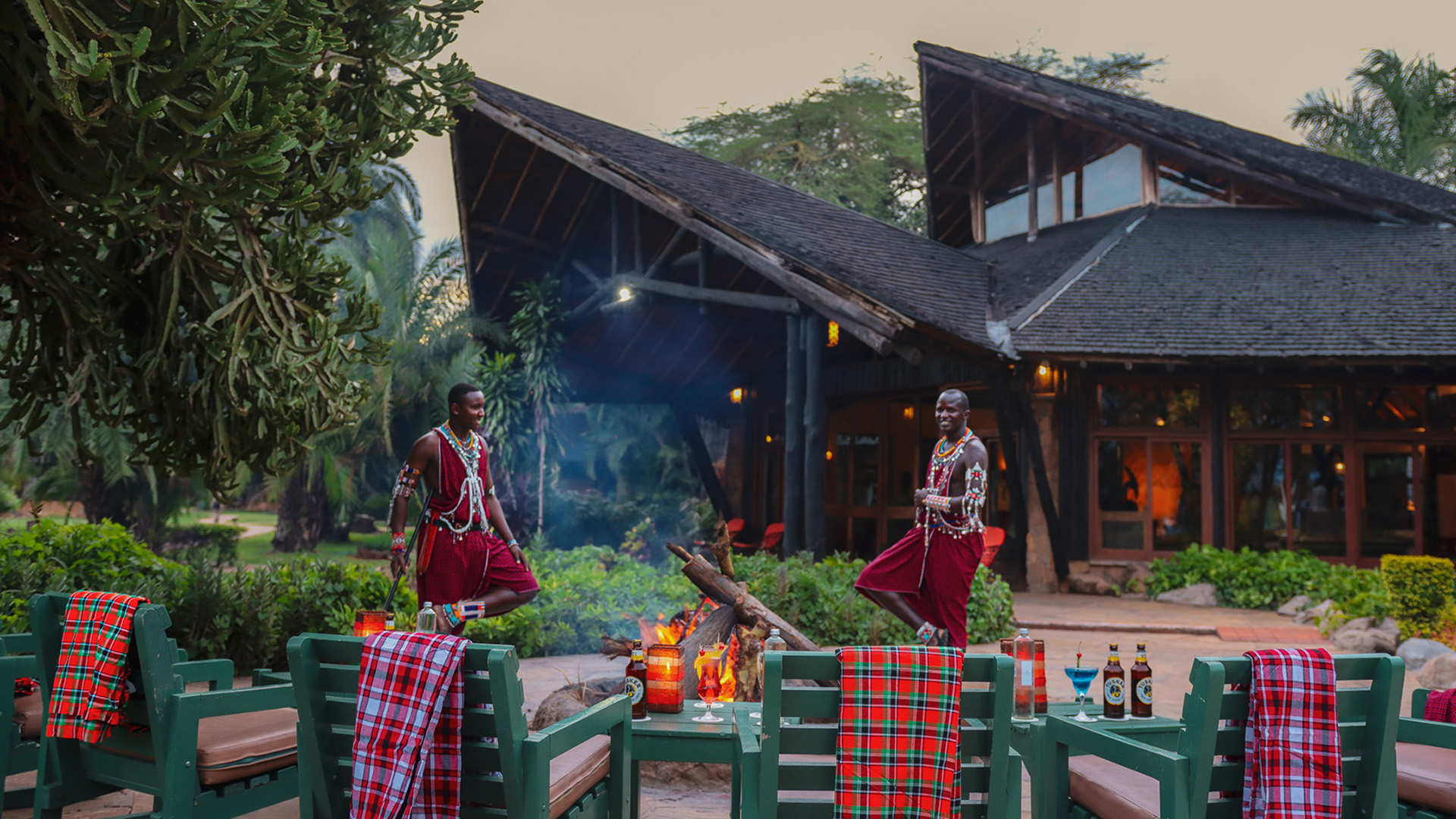 Evening bonfire with Maasai hosts and outdoor lounge seating at Ol Tukai Lodge, Amboseli