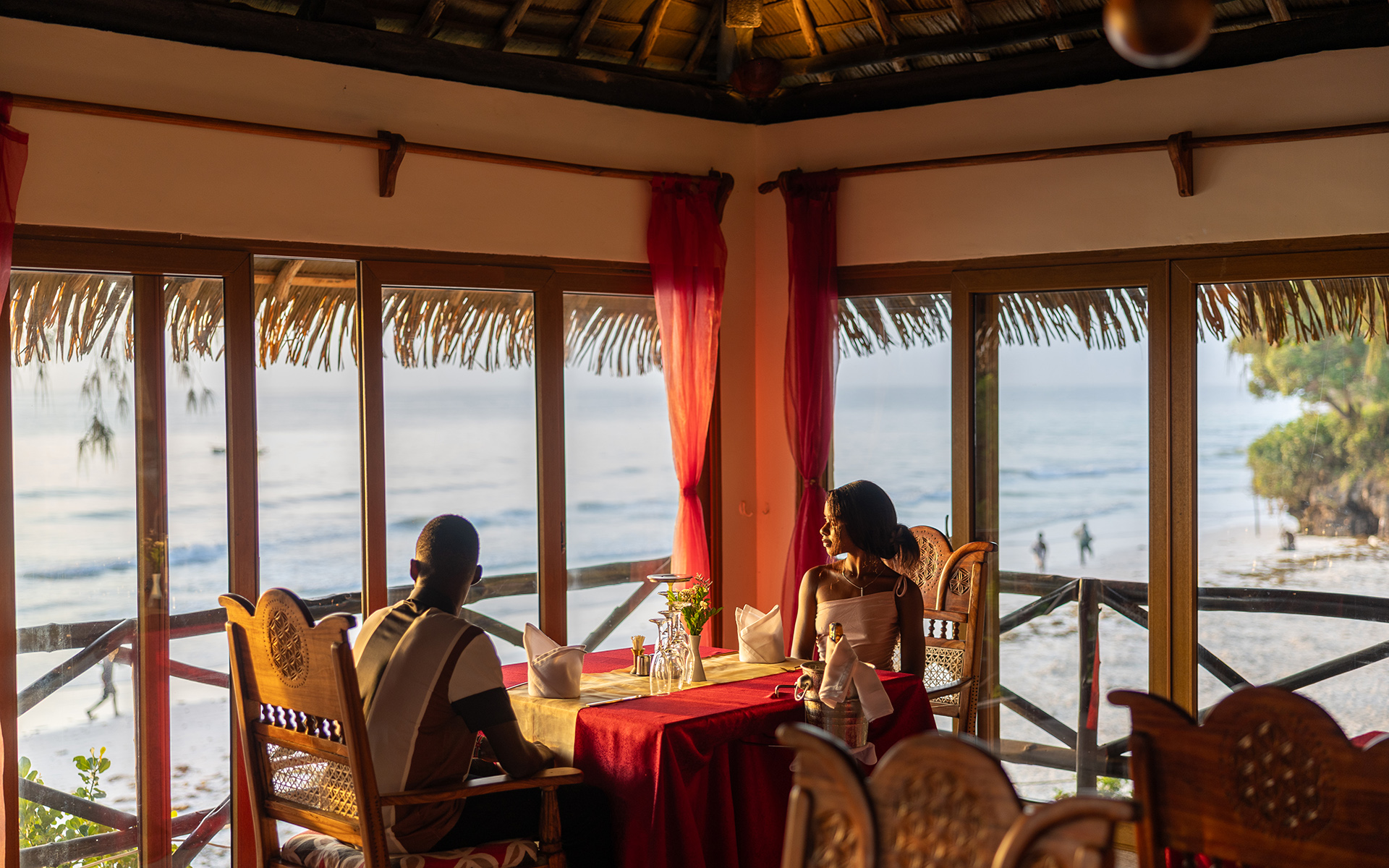 Couple dining with ocean views at Baobab Beach Resort restaurant