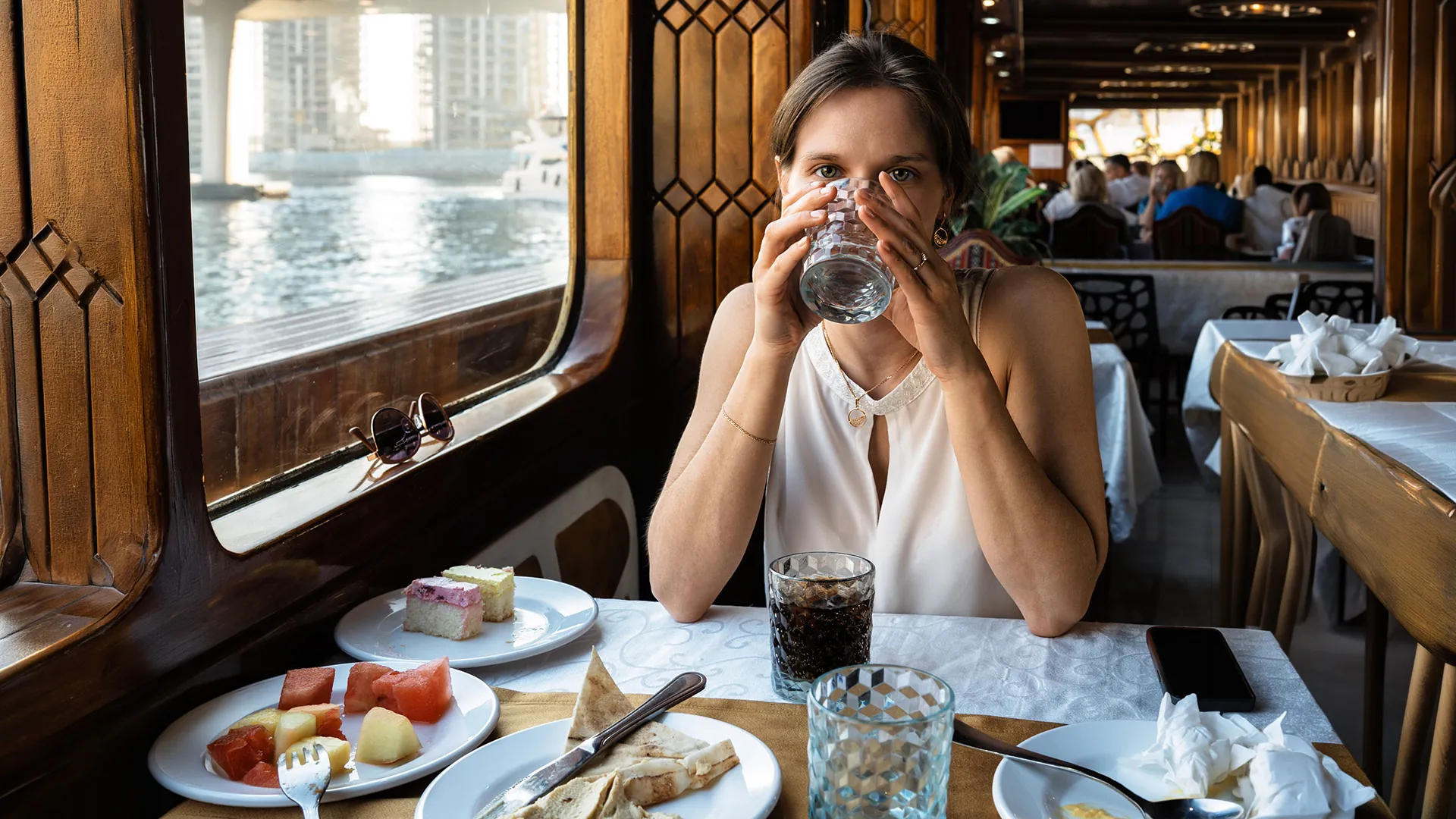 Guest dining aboard a traditional wooden dhow cruise on Dubai Marina