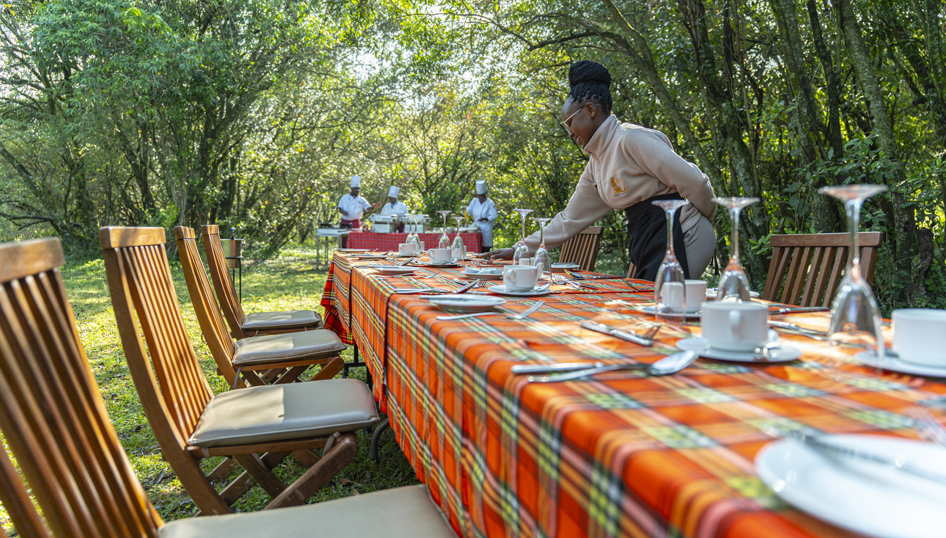 Outdoor bush breakfast table set among the trees on a Maasai Mara safari