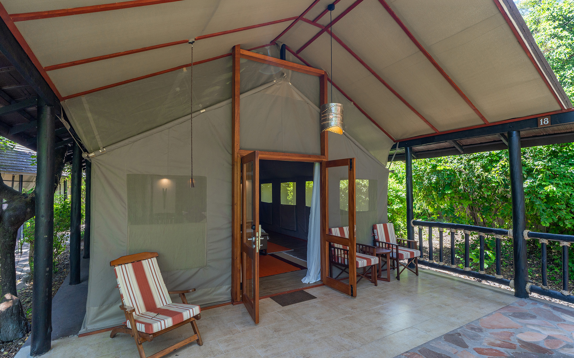 Guest tent exterior nestled in greenery at Sarova Mara Game Camp
