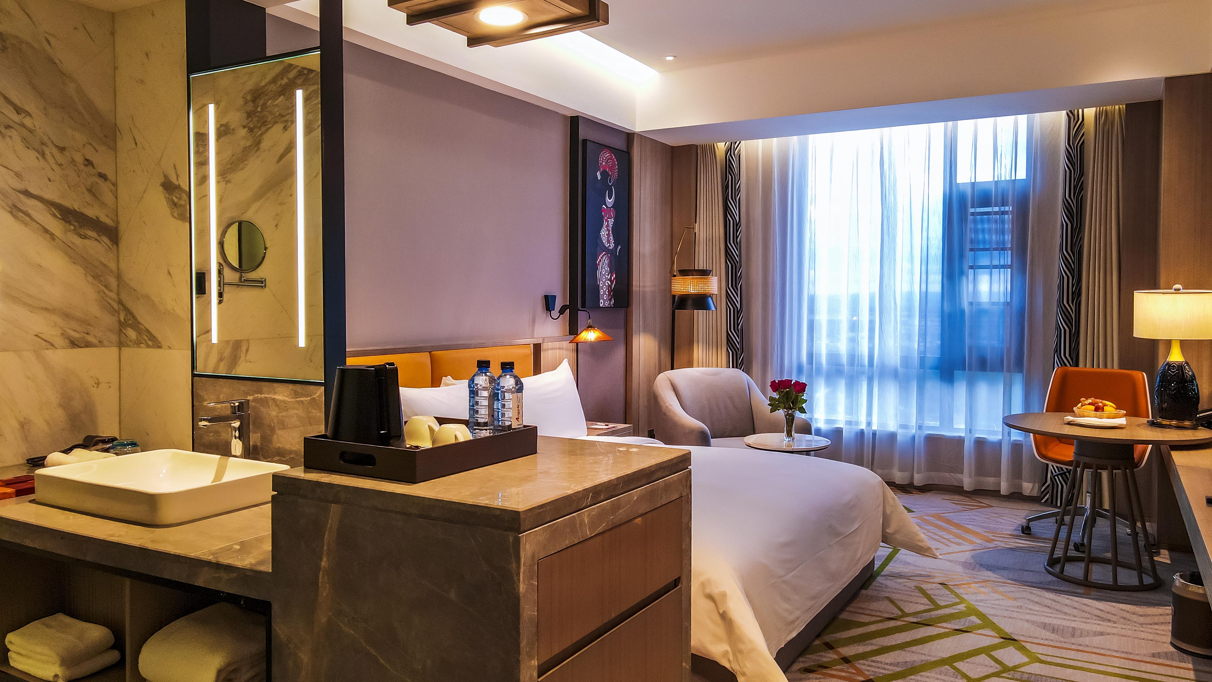 Modern hotel guest room with marble vanity and bed at Argyle Grand, Nairobi