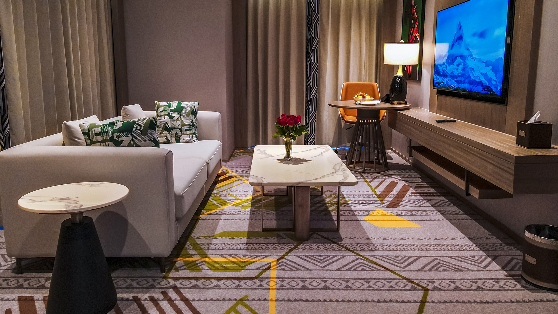 Modern hotel suite lounge with patterned rug at Argyle Grand, Nairobi
