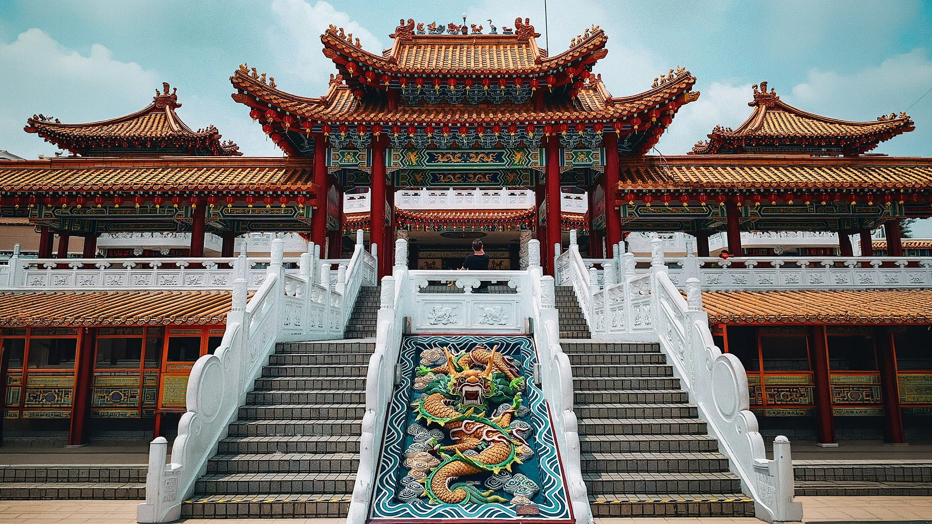 Thean Hou Temple facade with orange roofs, red lanterns, and a central dragon staircase in Kuala Lumpur