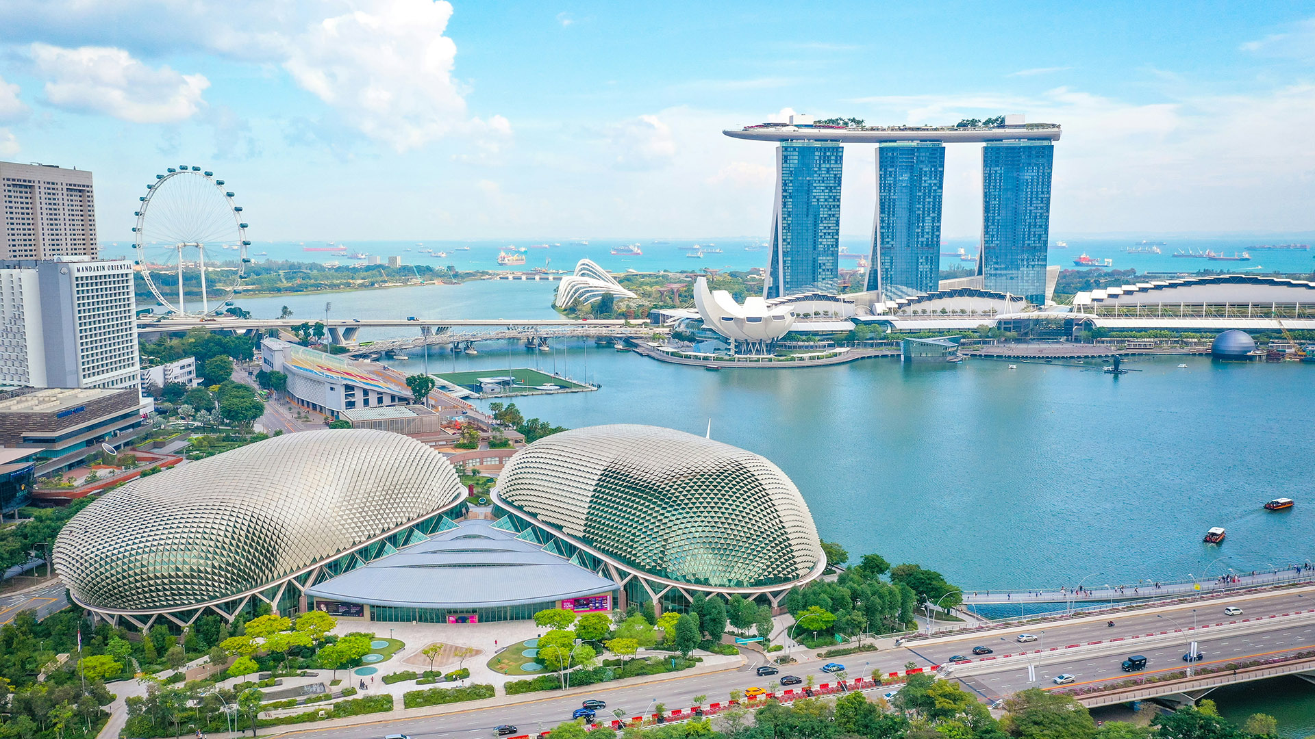 Daytime aerial of Marina Bay with Esplanade domes, Marina Bay Sands, and Singapore Flyer