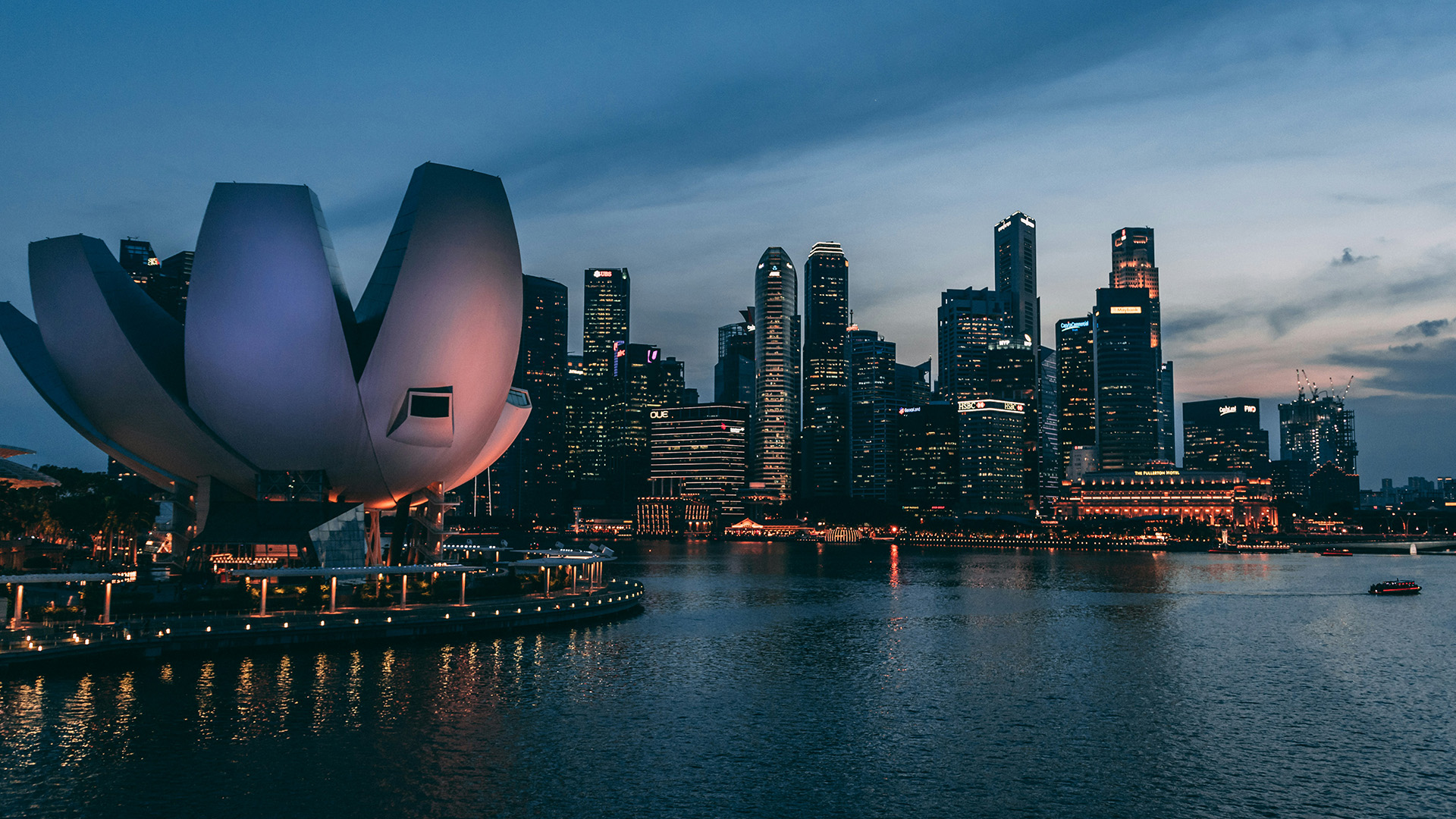 ArtScience Museum and illuminated Singapore CBD skyline across Marina Bay at twilight