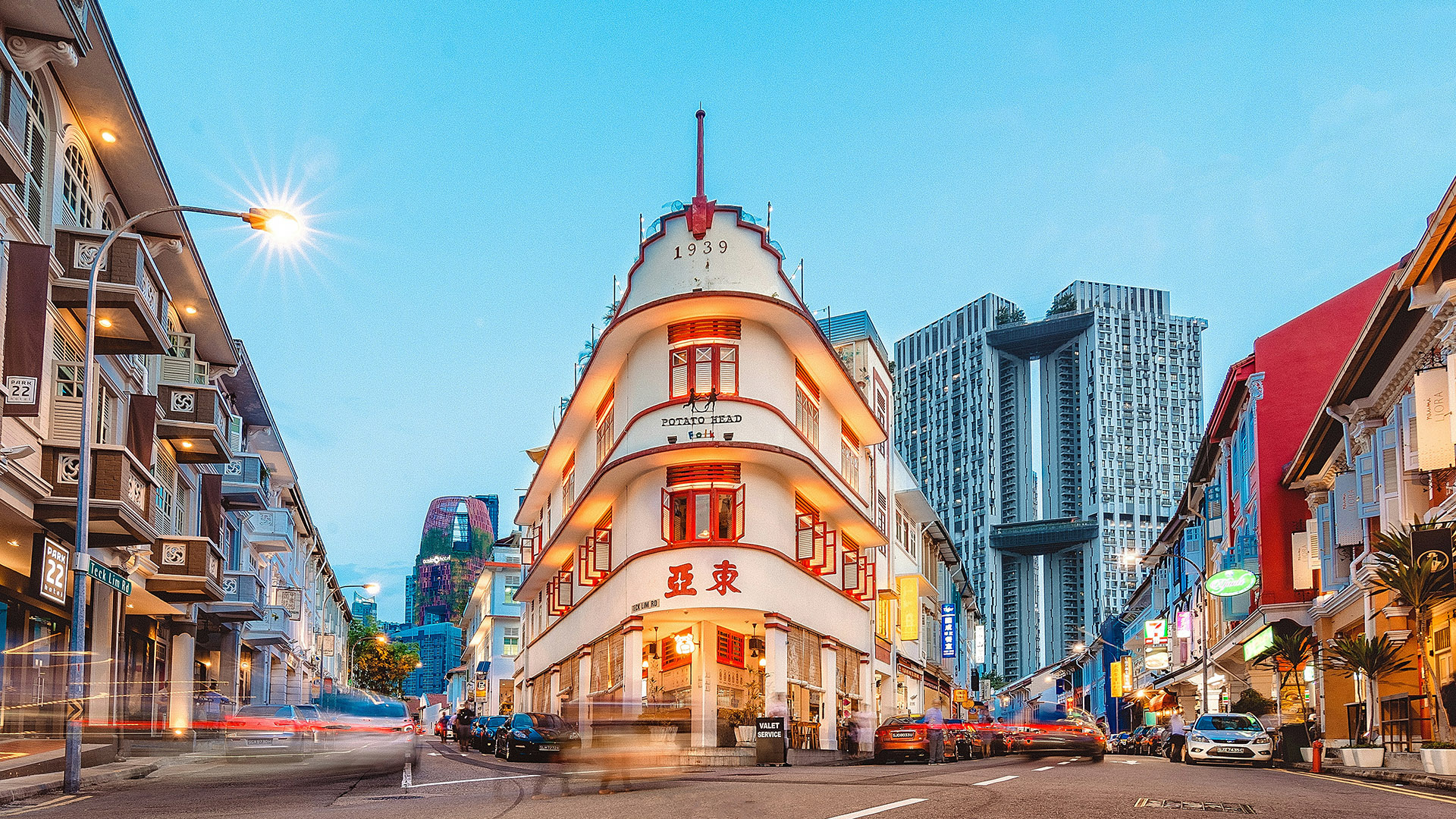 Keong Saik Road at dusk with heritage shophouses and modern towers behind