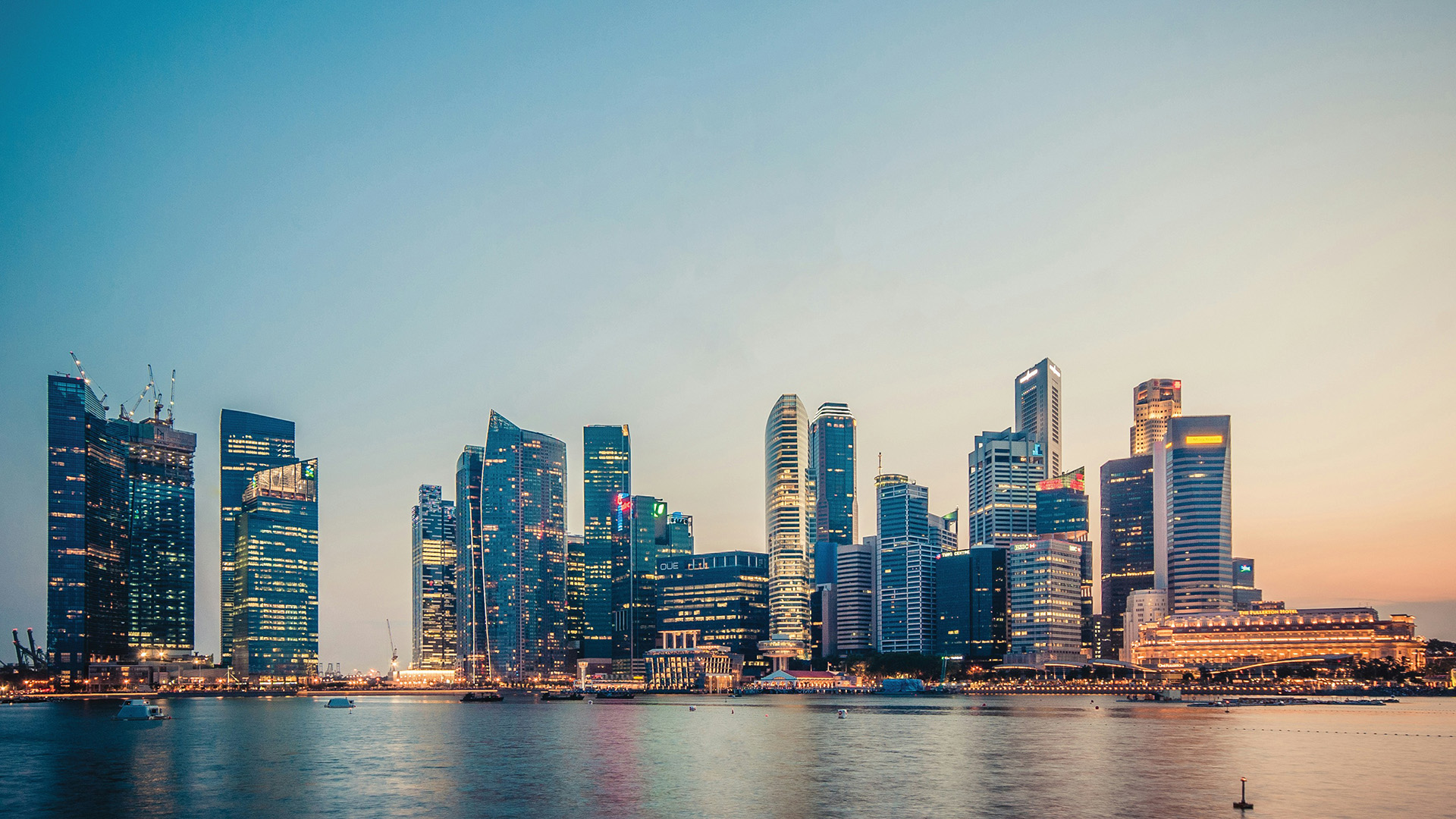 Singapore CBD skyline across the water at dusk