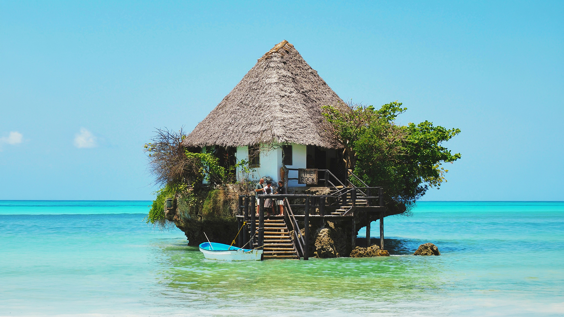 The Rock Restaurant perched on a rocky islet in clear turquoise Zanzibar water