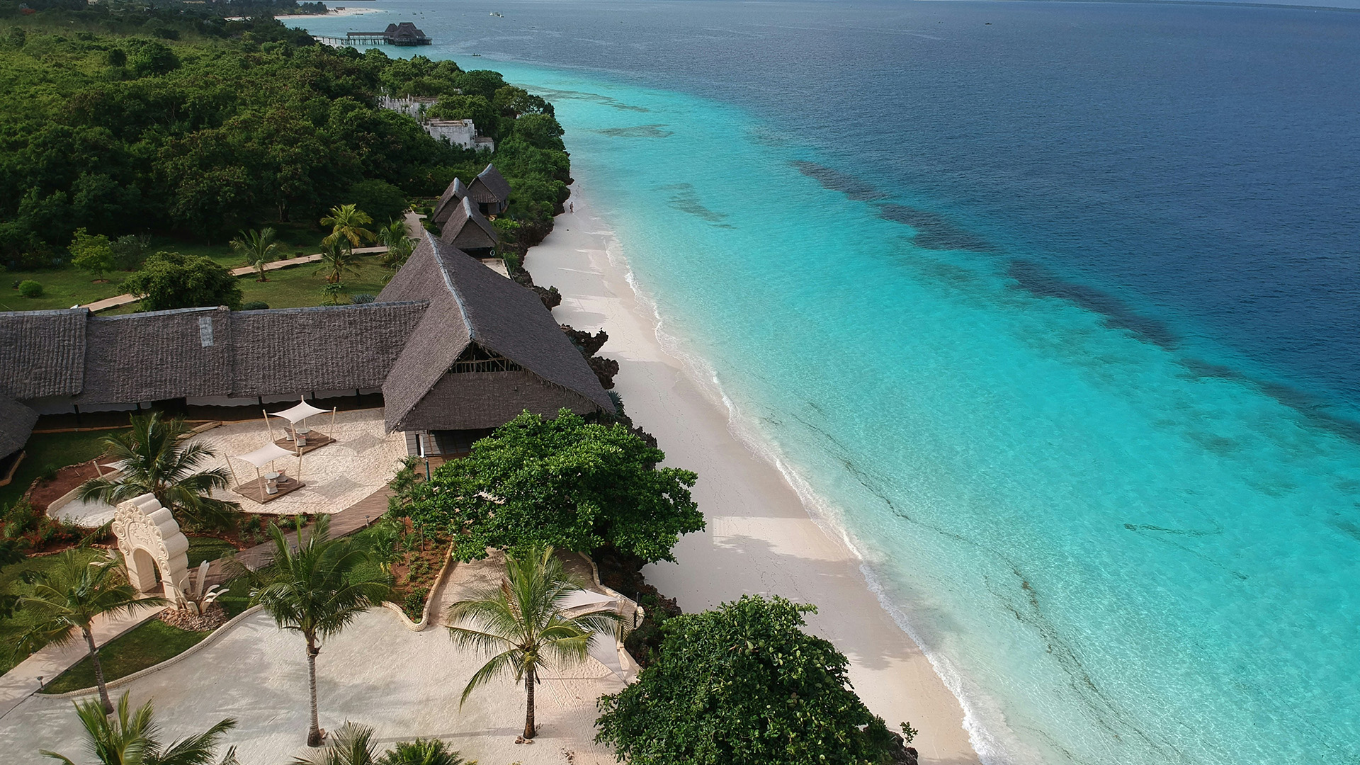 Aerial coastline of a tropical beach resort with white sand and turquoise sea